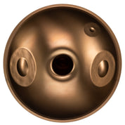 The YataoPan D Kurd 13 Ember by Yatao // Shop is a round, bronze handpan drum with a central hole and oval tone fields—perfect for beginners seeking quality sound and polished design.