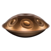 The YataoPan D Kurd 13 Ember by Yatao // Shop is a dome-shaped metallic handpan with a bronze finish and circular indentations, ideal for beginners, shown isolated on a white background.