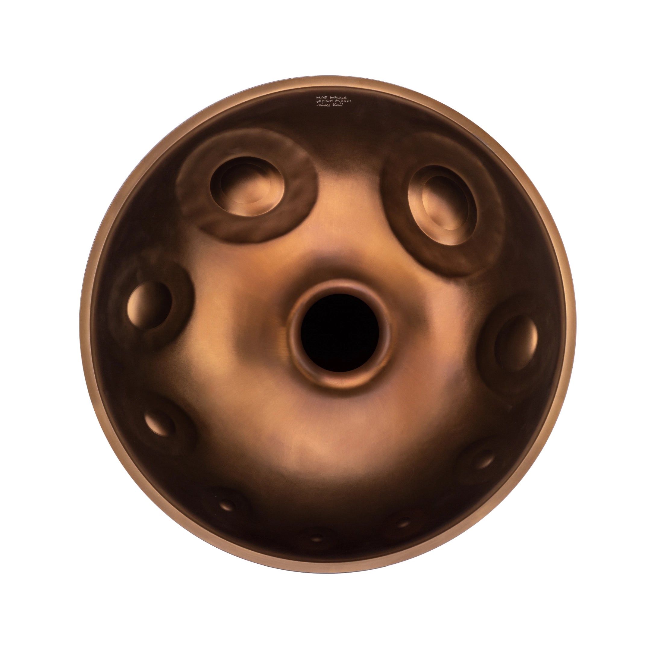 The MAG F# low pygmy 21 steel handpan drum by Yatao // Shop is shown from above, featuring a central hole and circular indentations on its surface against a white background.