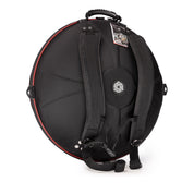 The TurtleCase Handpan Bag Evatek 2.0 medium HCT is a black, round case with backpack straps, a handle, central circular logo, red edge trim, and an attached product tag reflecting quality craftsmanship.