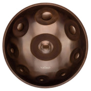 A metallic YataoPan C# Pygmy 9 handpan by Yatao // Shop, viewed from above, shows a central dome and several circular indentations, with the shop’s label visible near the bottom.