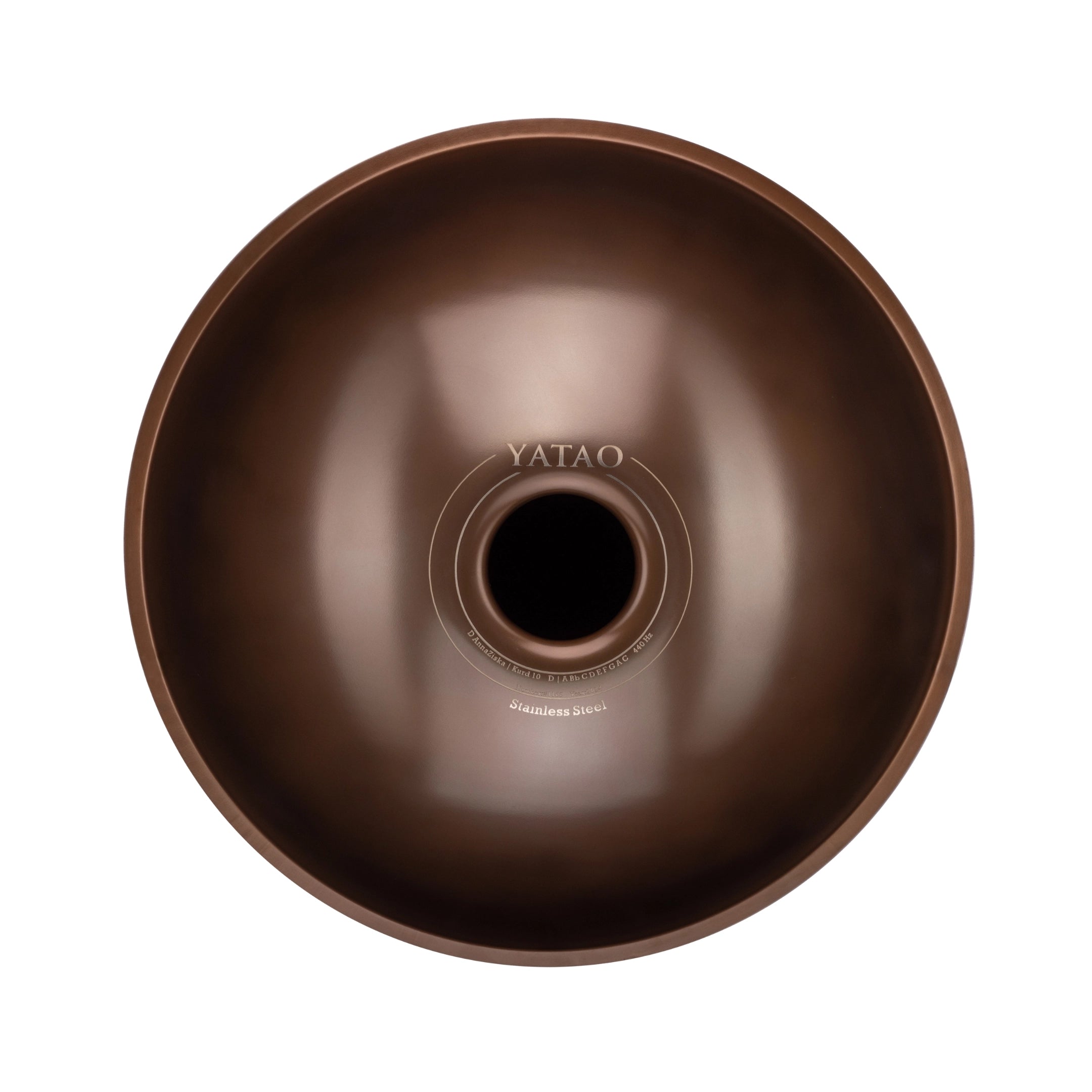 A top-down view of the YataoPan D Kurd 10, a round metallic brown handpan drum from Yatao // Shop, featuring stainless steel printed near its central opening.