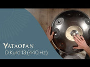 A person plays a Yataopan D Kurd 13 (440 Hz) handpan drum, resting it on their lap. The text “YATAOPAN D Kurd 13 (440 Hz)” appears on the left. Discover more at a Handpan Shop Germany or Buy Handpan online.