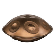 MAG C# Pygmy 17 handpan with 17 notes in a warm gold finish, crafted from Ember Steel, shown from a side perspective on a white background